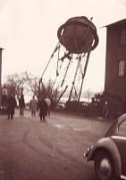Ein Schwarzweißfoto eines vor einem Gebäude geparkten Autos.