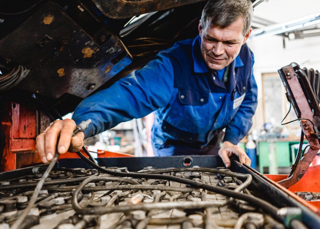 Mitarbeiter arbeitet an einem aufgekippten Gabelstapler