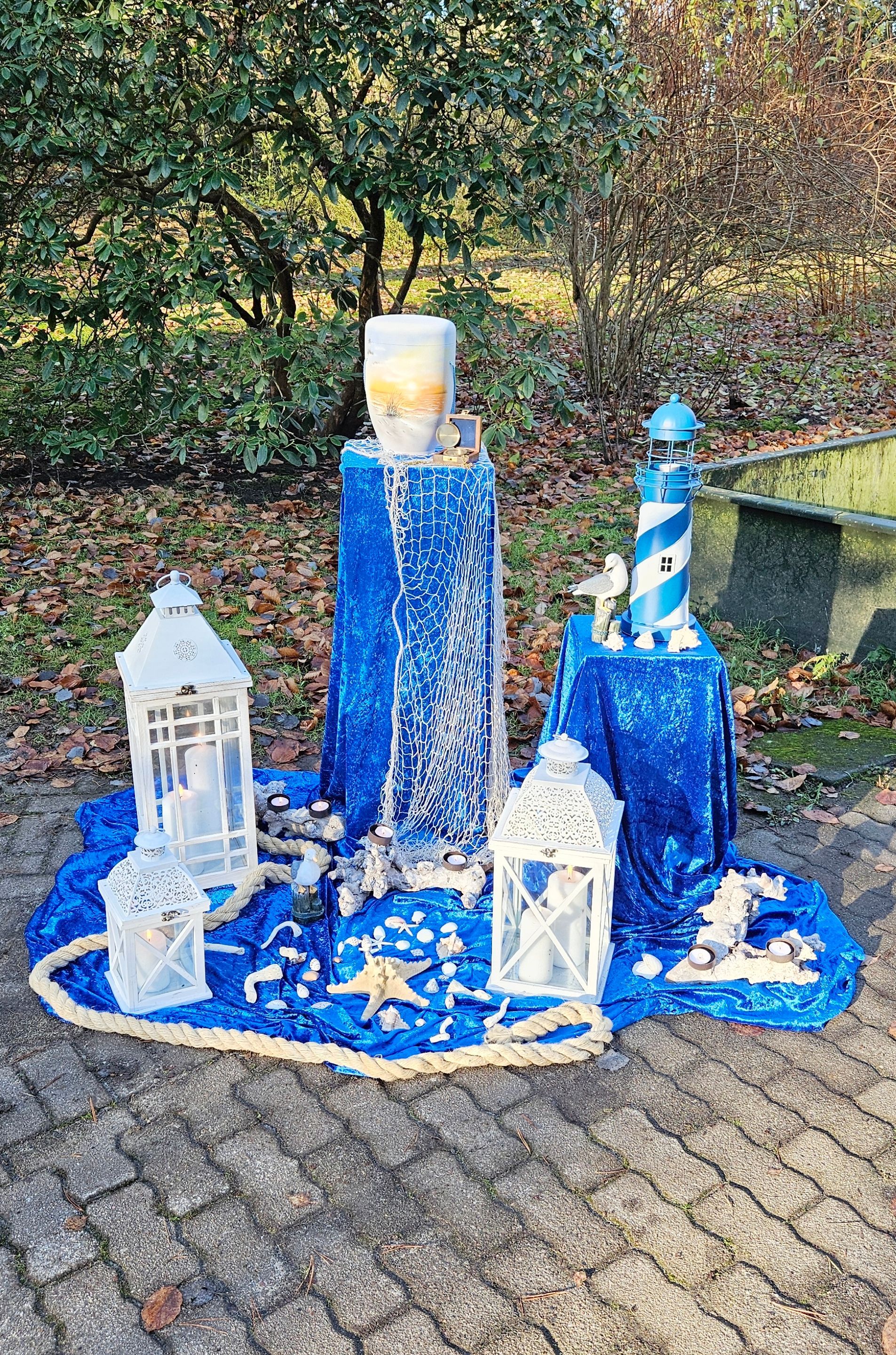 Eine Gruppe von Laternen und Kerzen steht auf einem blauen Tisch.