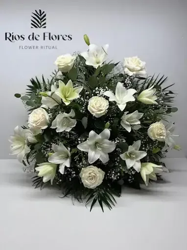 Lirios blancos y rosas dispuestos en una exhibición floral.