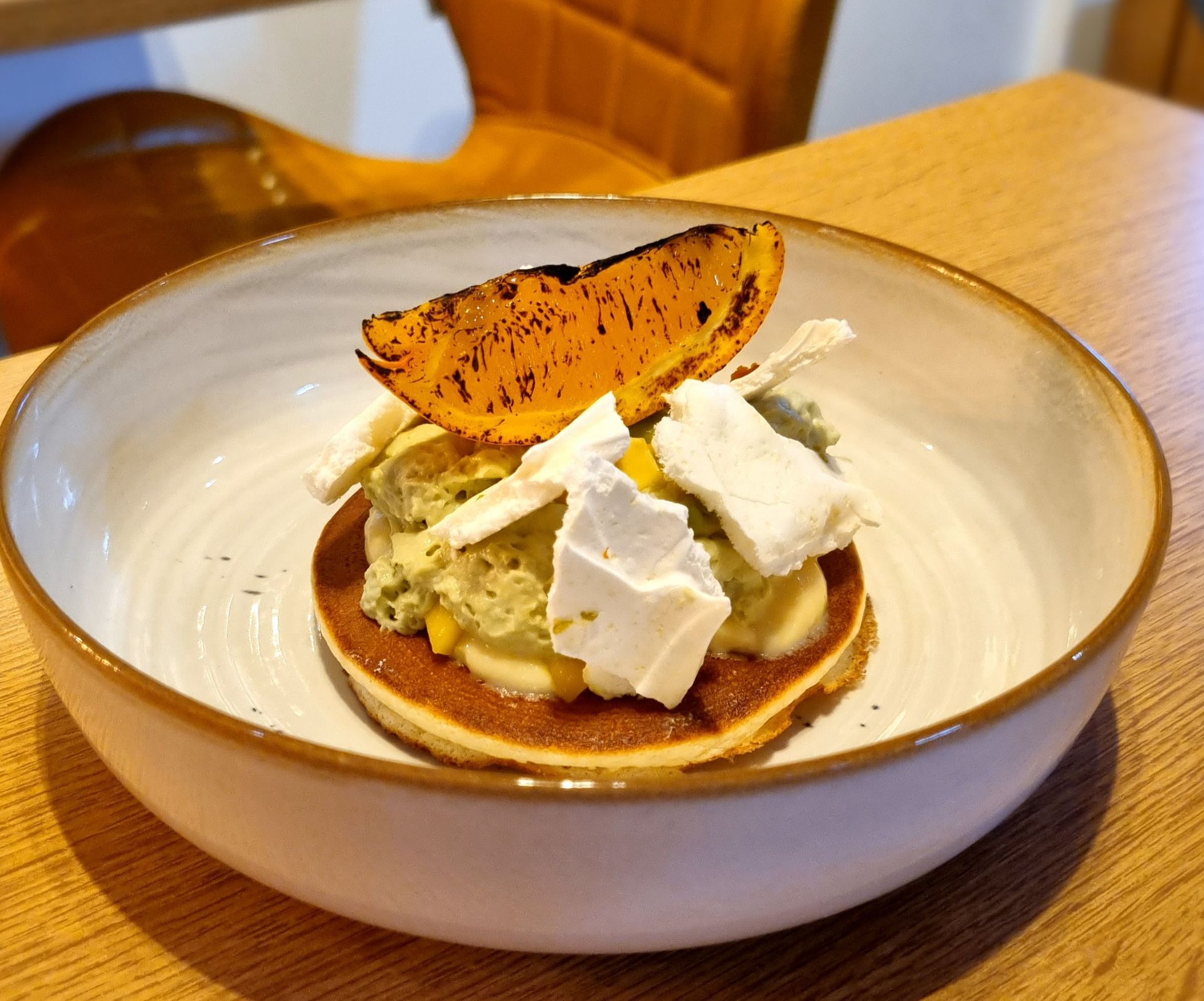 Pancake avec une mousse de fruit et un quartier d'orange
