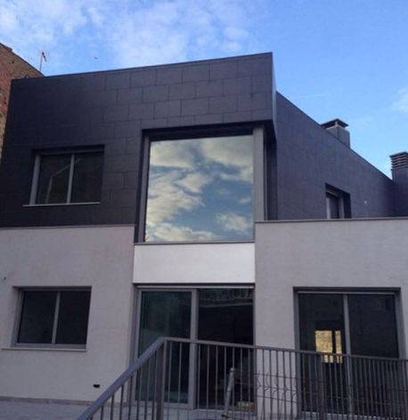 Un edificio con una gran ventana y escaleras que conducen a él.
