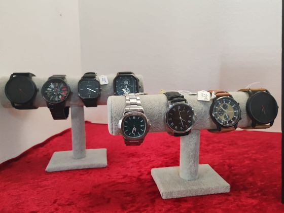 Montres-bracelets assorties présentées sur des supports gris en tissu.