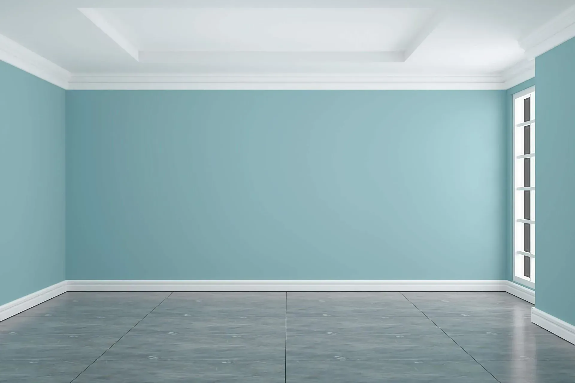 Pièce vide avec des murs bleu sarcelle, des garnitures blanches et un sol carrelé gris ; une fenêtre se trouve dans le coin.