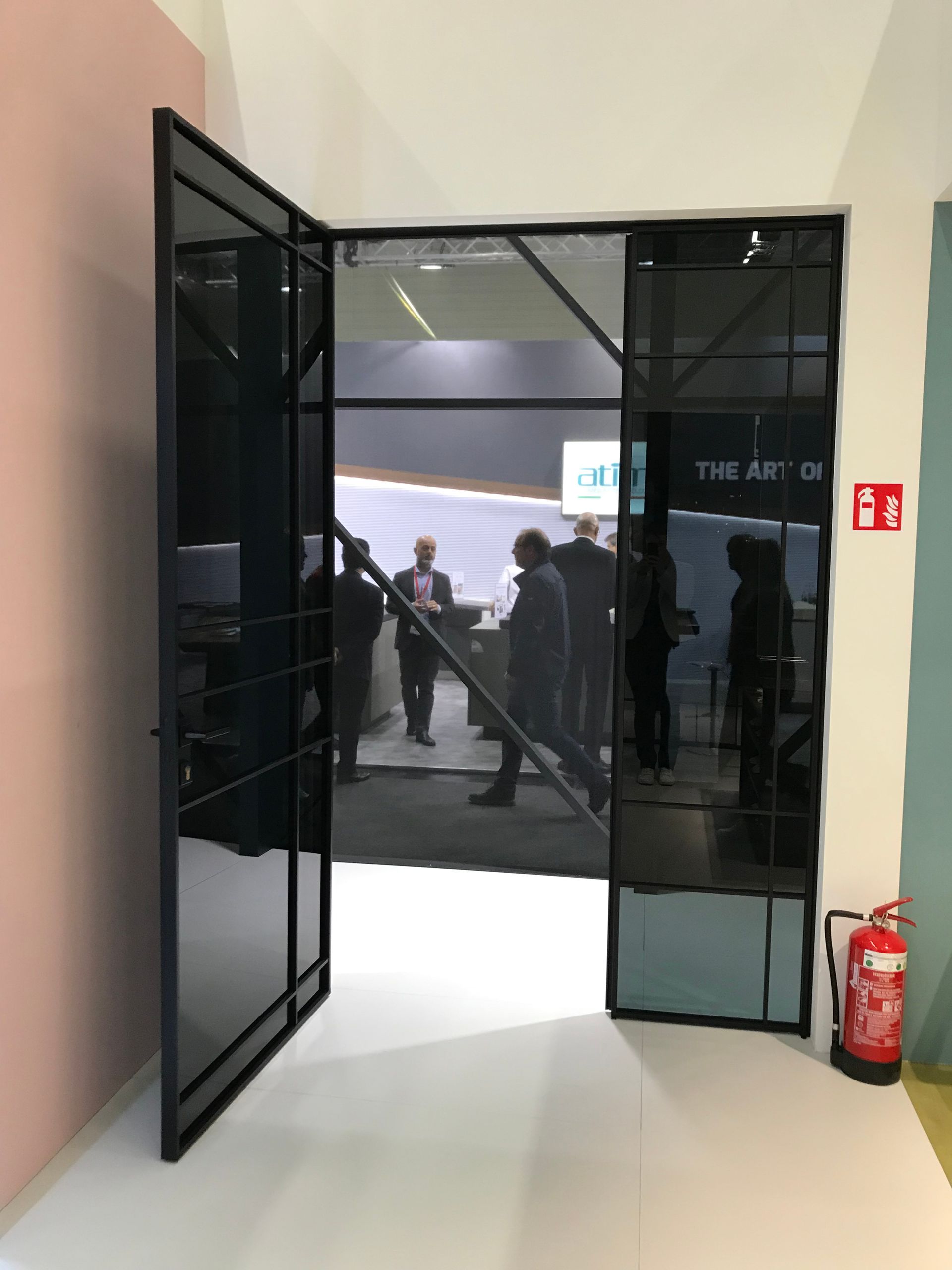 Eine Gruppe von Leuten steht in einem Raum. Auf dem Boden liegt ein Feuerlöscher. Wohntrend NRW Raumplus