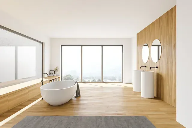 Un baño con bañera, lavabo y un gran ventanal.