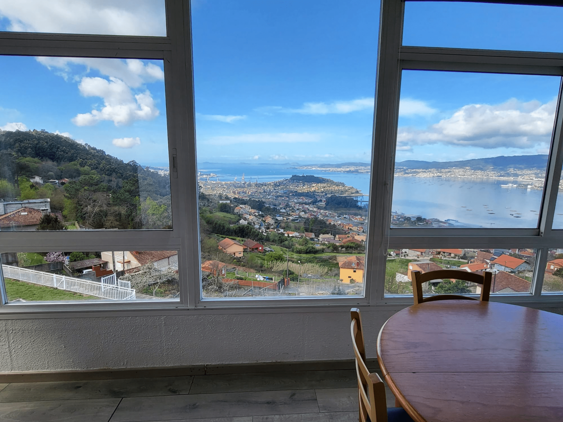 Una habitación con mesa y sillas y vista al mar.