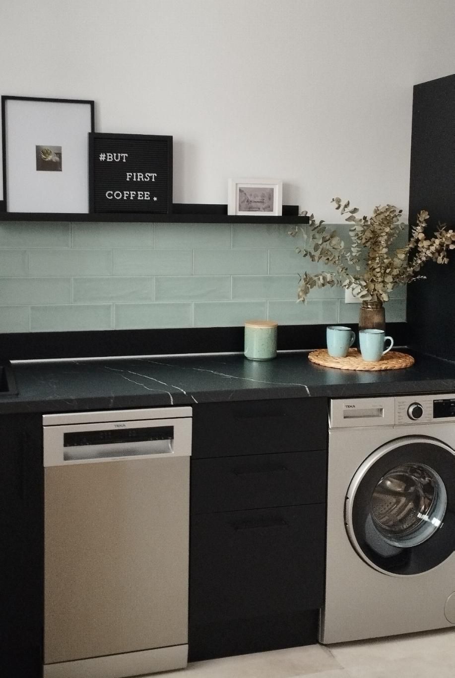 Encimera de cocina moderna con fregadero, lavavajillas, lavadora, salpicadero de azulejos color menta y elementos decorativos