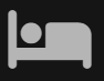 Un icono blanco de una persona acostada en una cama sobre un fondo negro.