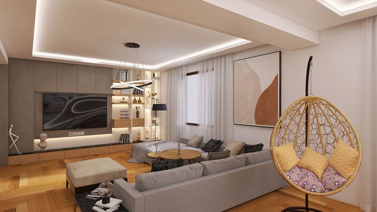 Salon moderne avec un canapé d’angle, un téléviseur mural, un éclairage chaleureux et un fauteuil suspendu.