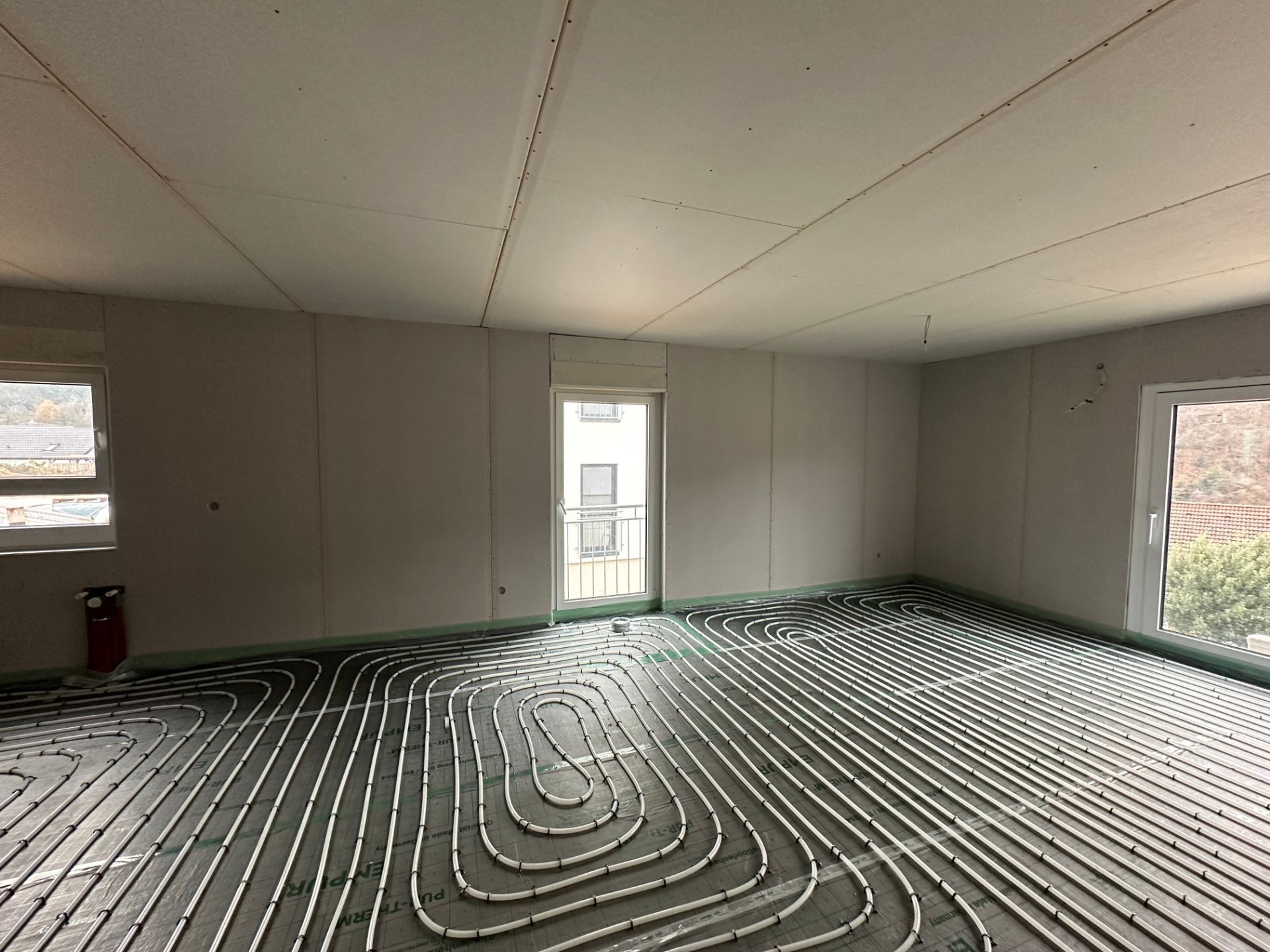 Raum mit fertiger Trockenbauwand und Fenster im Ausbau