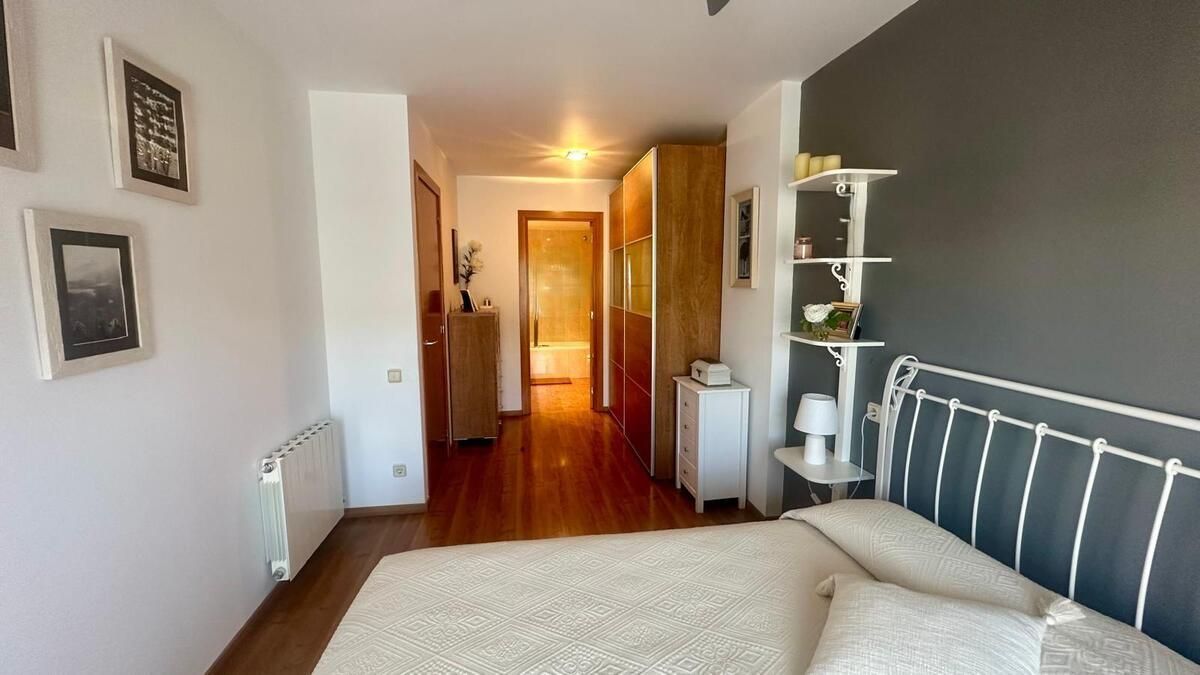 Un dormitorio con una cama y un pasillo que conduce a un baño.