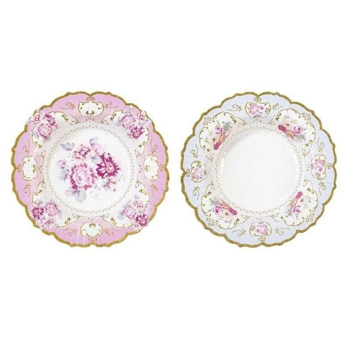 Dos platos de porcelana ornamentados con motivos florales, uno rosa y otro blanco con ribete dorado.