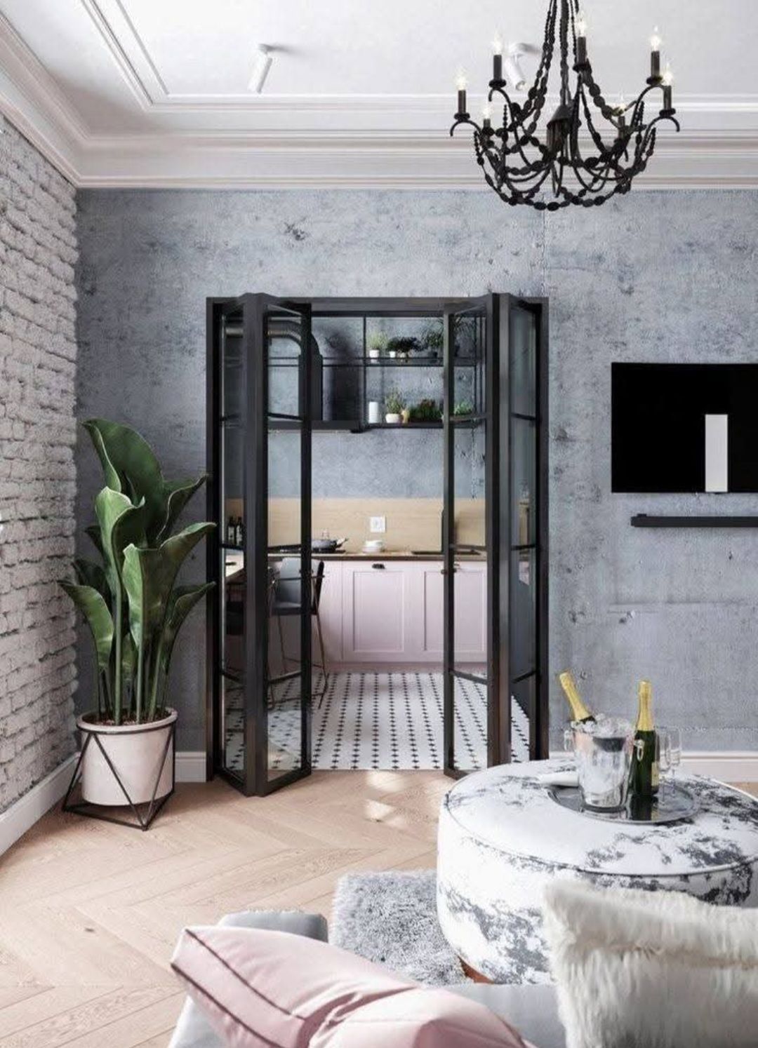 Salon avec portes vitrées à cadre noir donnant sur une cuisine