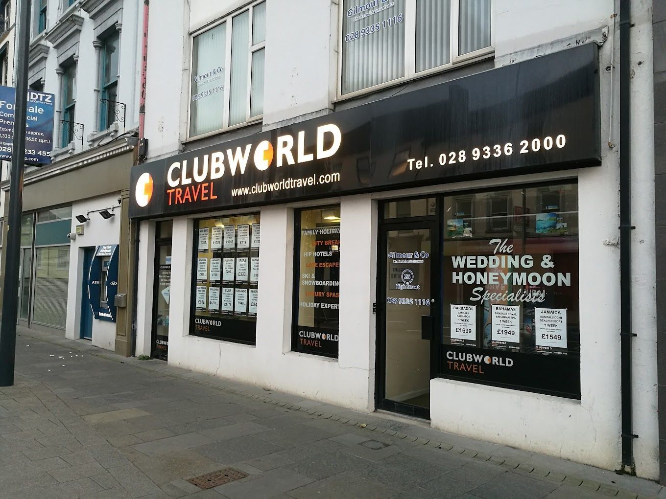 A clubworld travel store is located on a city street.