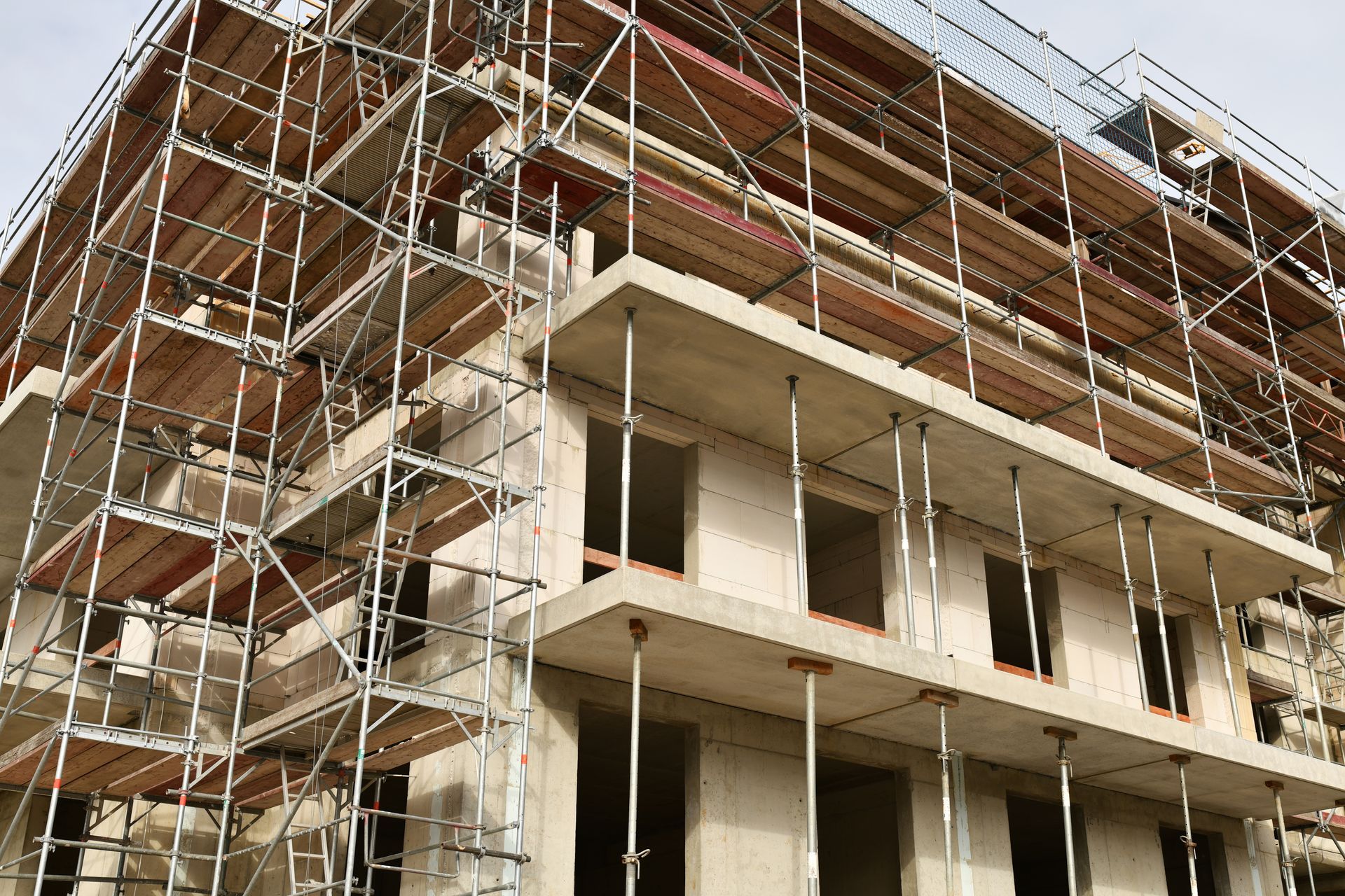 Das Gebäude befindet sich im Bau, ein Gerüst umgibt die Betonkonstruktion.