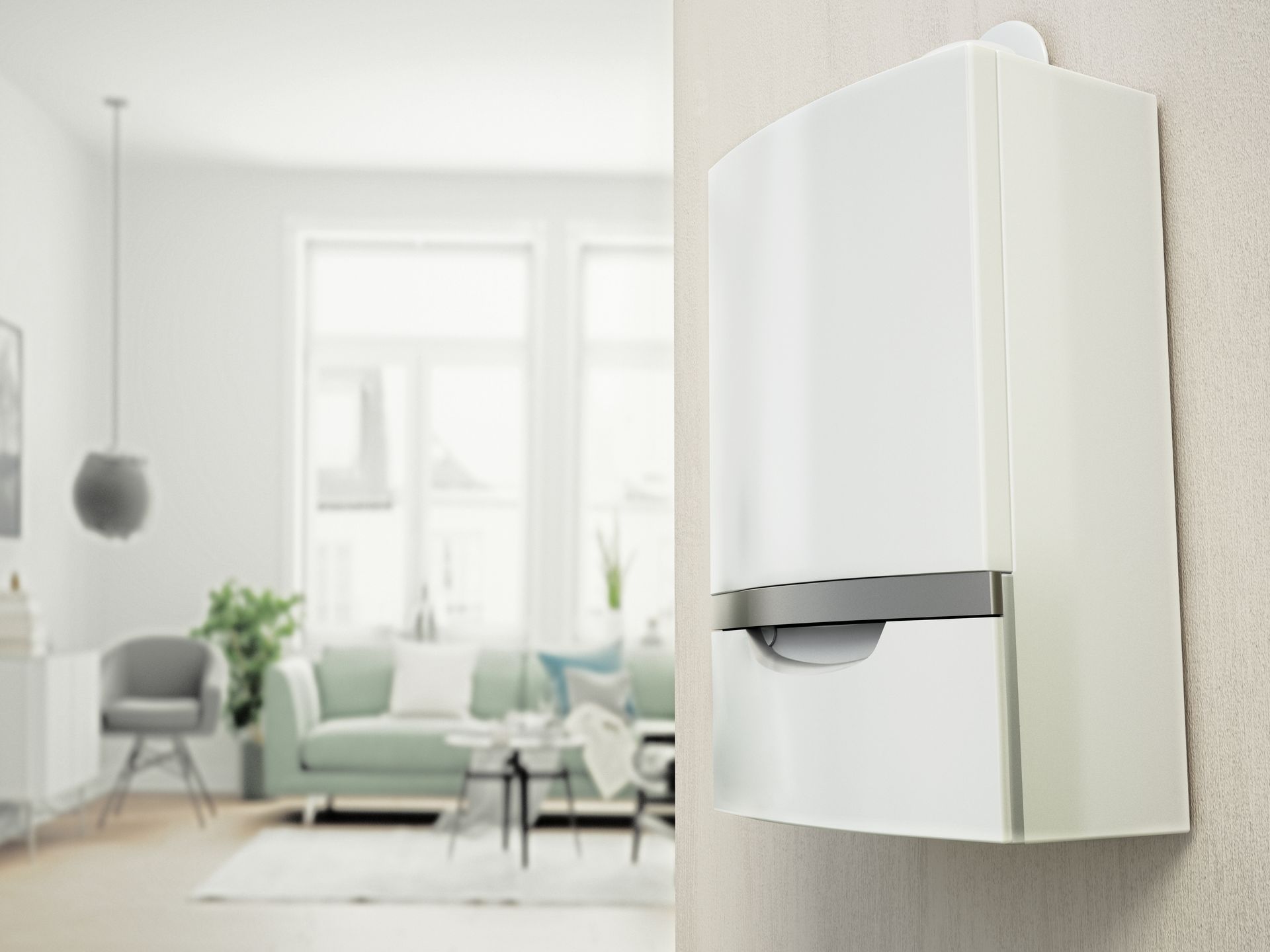 Un appareil électroménager blanc fixé au mur dans un salon lumineux, avec des canapés et une fenêtre en arrière-plan.