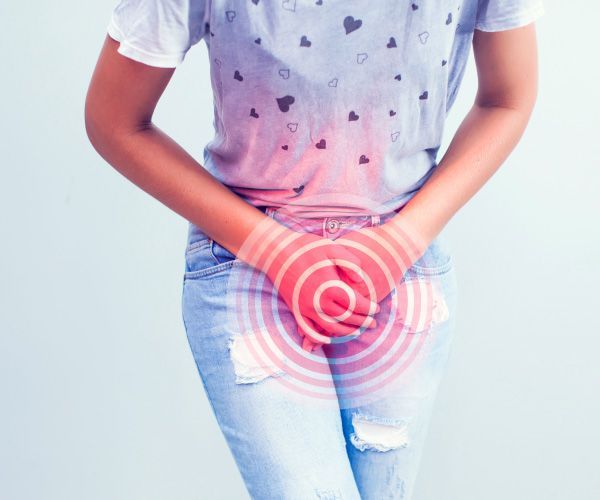 Una mujer se sostiene el abdomen inferior con dolor.