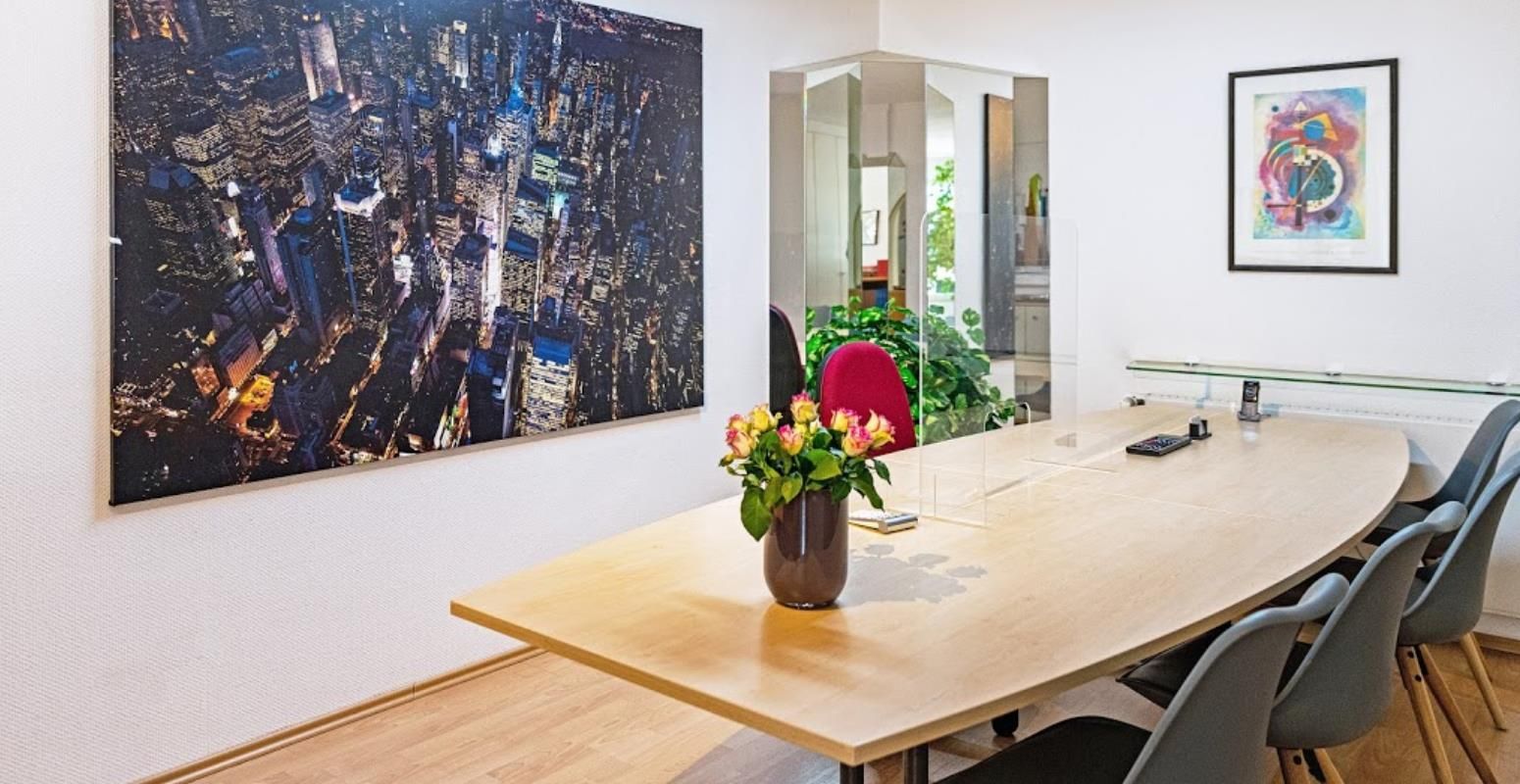 Ein langer Holztisch mit einer Vase mit Blumen darauf