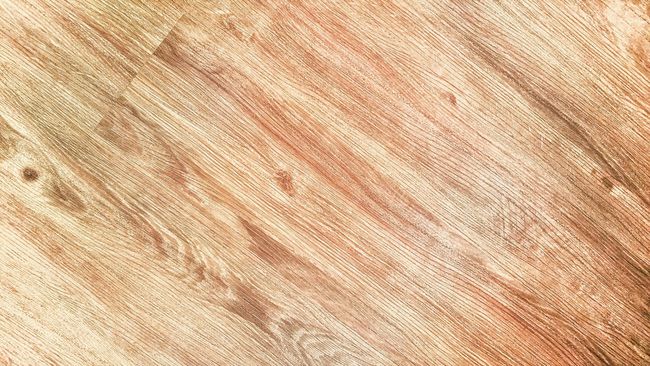 Primer plano de la veta de la madera con texturas de color marrón claro, tostado y marrón que recorren el marco en diagonal.