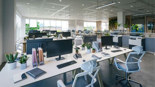 Un open space baigné de lumière naturelle, avec des rangées de bureaux blancs équipés d'ordinateurs modernes, de chaises ergonomiques et de petites plantes.