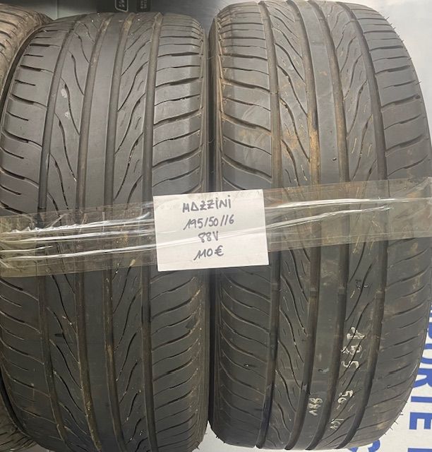 Un par de neumáticos están envueltos en plástico y tienen una etiqueta que dice 'adzfini'.