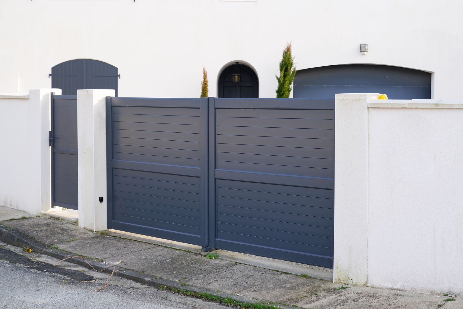 Un portail moderne devant une maison.