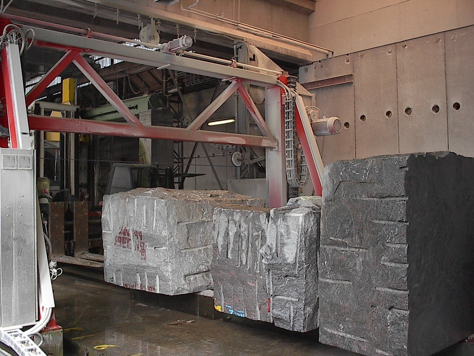 Eine Maschine schneidet in einer Fabrik große Granitblöcke