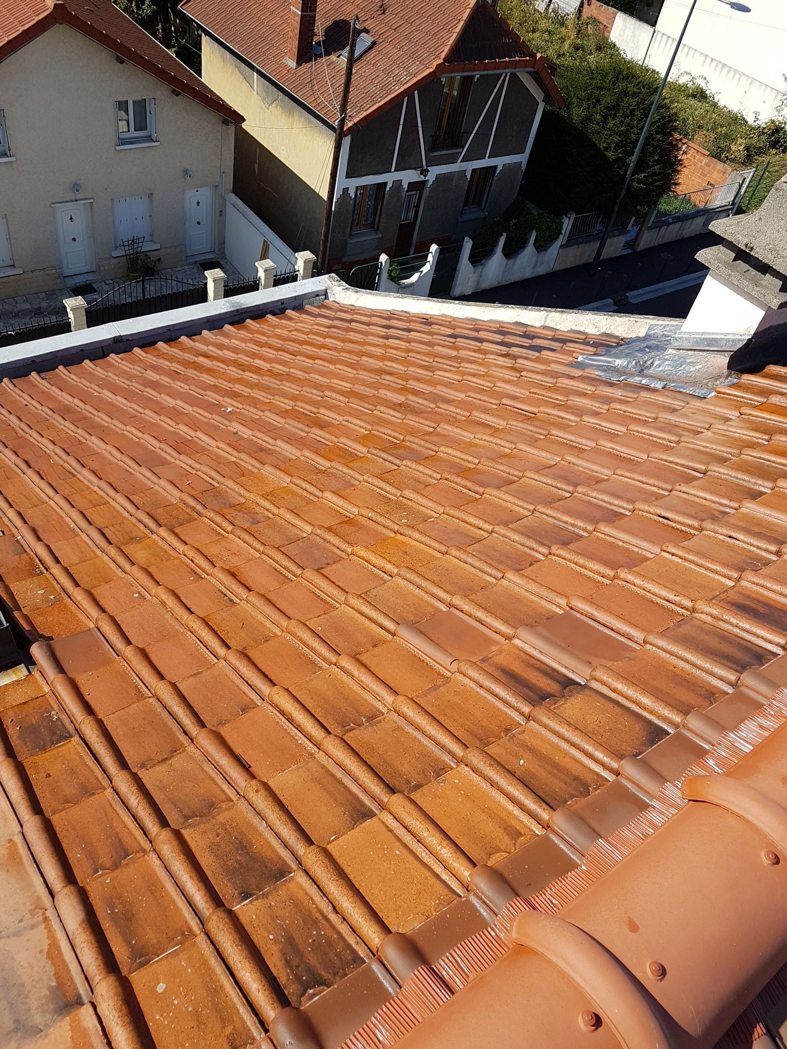Application d'un produit au pulvérisateur le long du bord d'un toit.