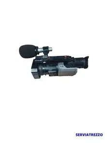 Una cámara de vídeo con un micrófono conectado a ella sobre un fondo blanco.