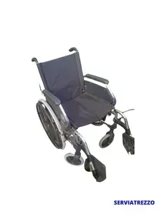 Una silla de ruedas negra está sentada sobre un fondo blanco.