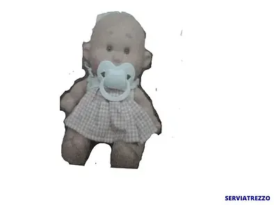 Un muñeco con un chupete en la boca