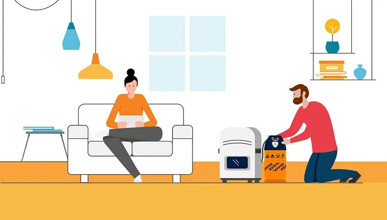 Un hombre está arrodillado junto a una mujer sentada en un sofá en una sala de estar.