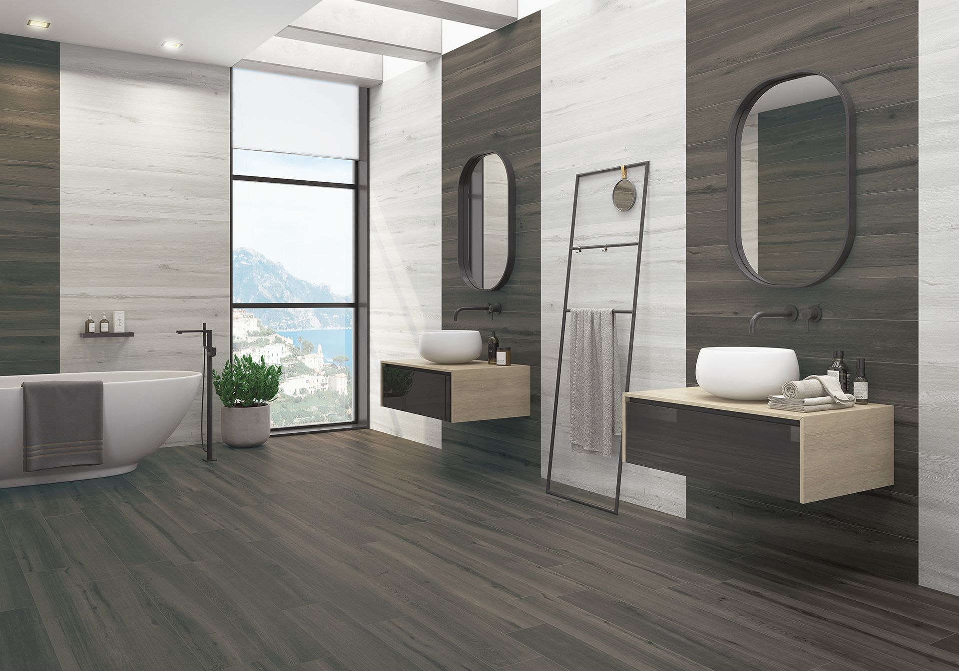 Salle de bains moderne avec des boiseries foncées et des murs blancs, deux lavabos, baignoire et grande fenêtre avec vue sur la montagne.