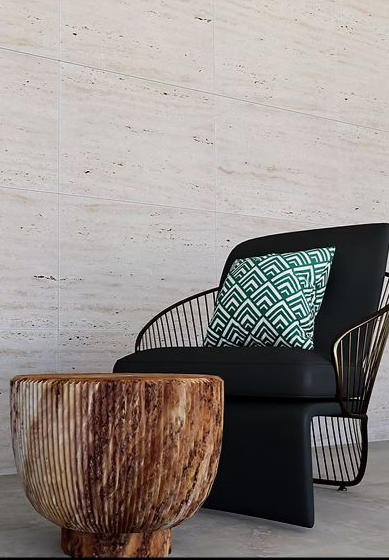 Une scène extérieure moderne avec une chaise noire, une table d'appoint en bois et un coussin à motifs contre un mur en pierre.