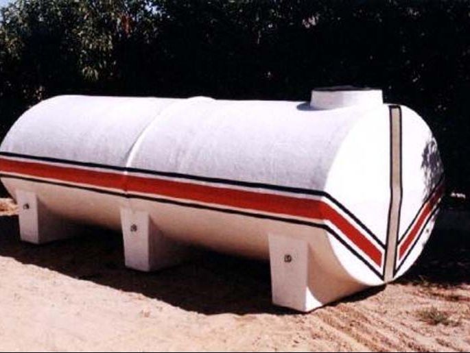 Un gran tanque blanco con rayas rojas y negras.