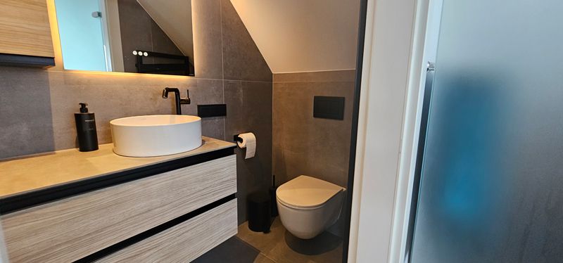 Ein Badezimmer mit Waschbecken, Schränken und Badewanne