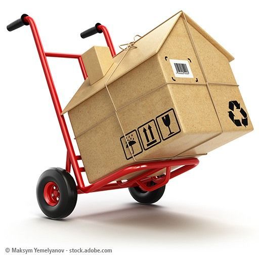 Delivery or moving houseconcept. Hand truck with cardboard box a
