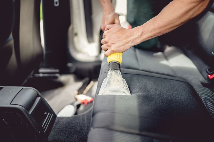 Nettoyage à l’injecteur extracteur d’un siège de voiture en tissu.