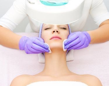 Una mujer está recibiendo un tratamiento facial en un salón de belleza.