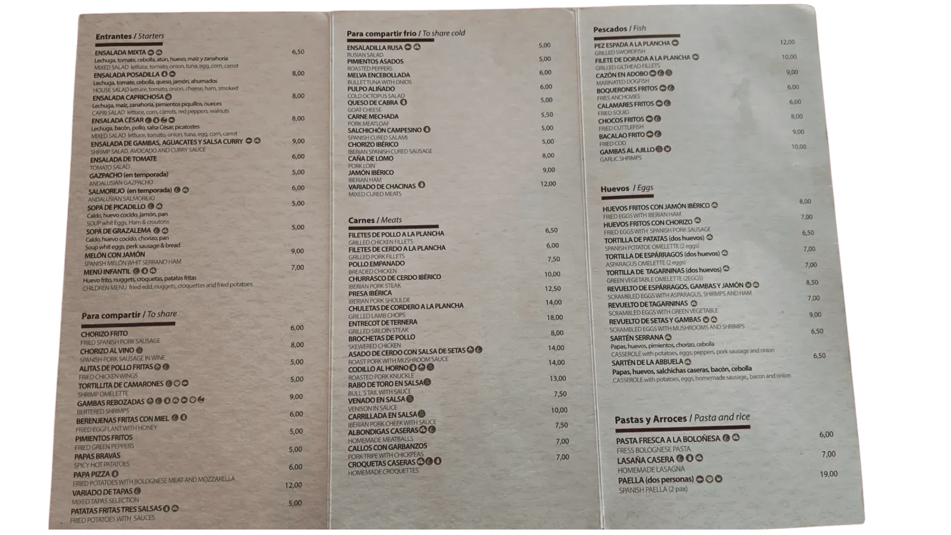 Menú impreso en papel beige. Diversos platos y precios en varias columnas.