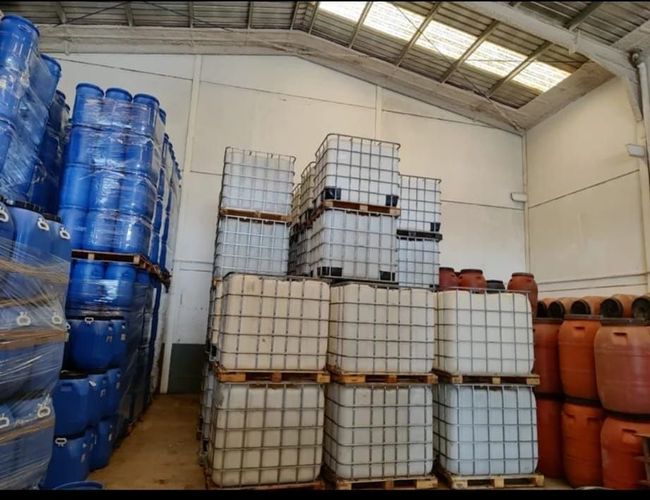Un almacén lleno de muchos contenedores y barriles.