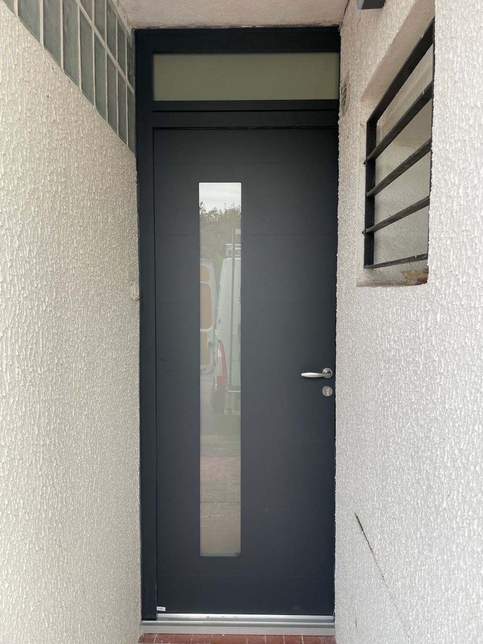 Porte d'entrée avec une vitre permettant le passage de la lumière