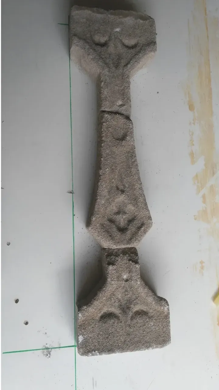 Balaustre decorativo de piedra con tallas ornamentadas.