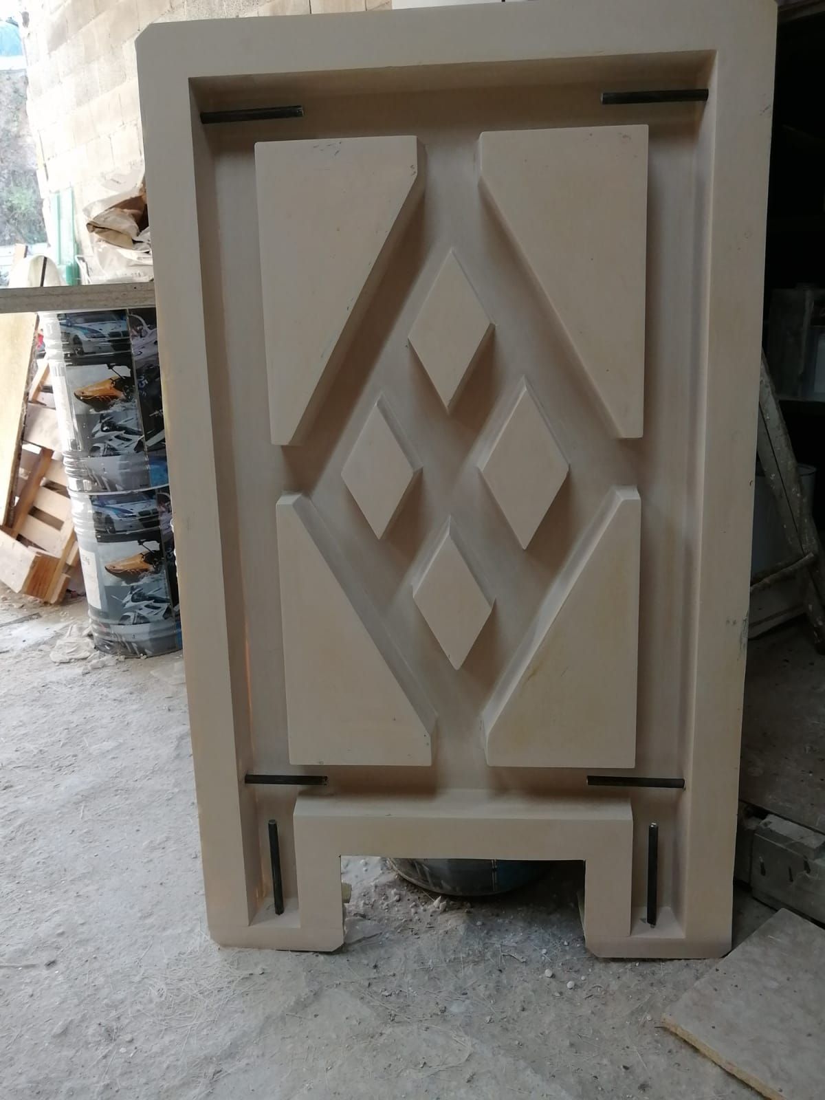 Panel geométrico de color canela con formas de rombos y triángulos, posiblemente un elemento decorativo.