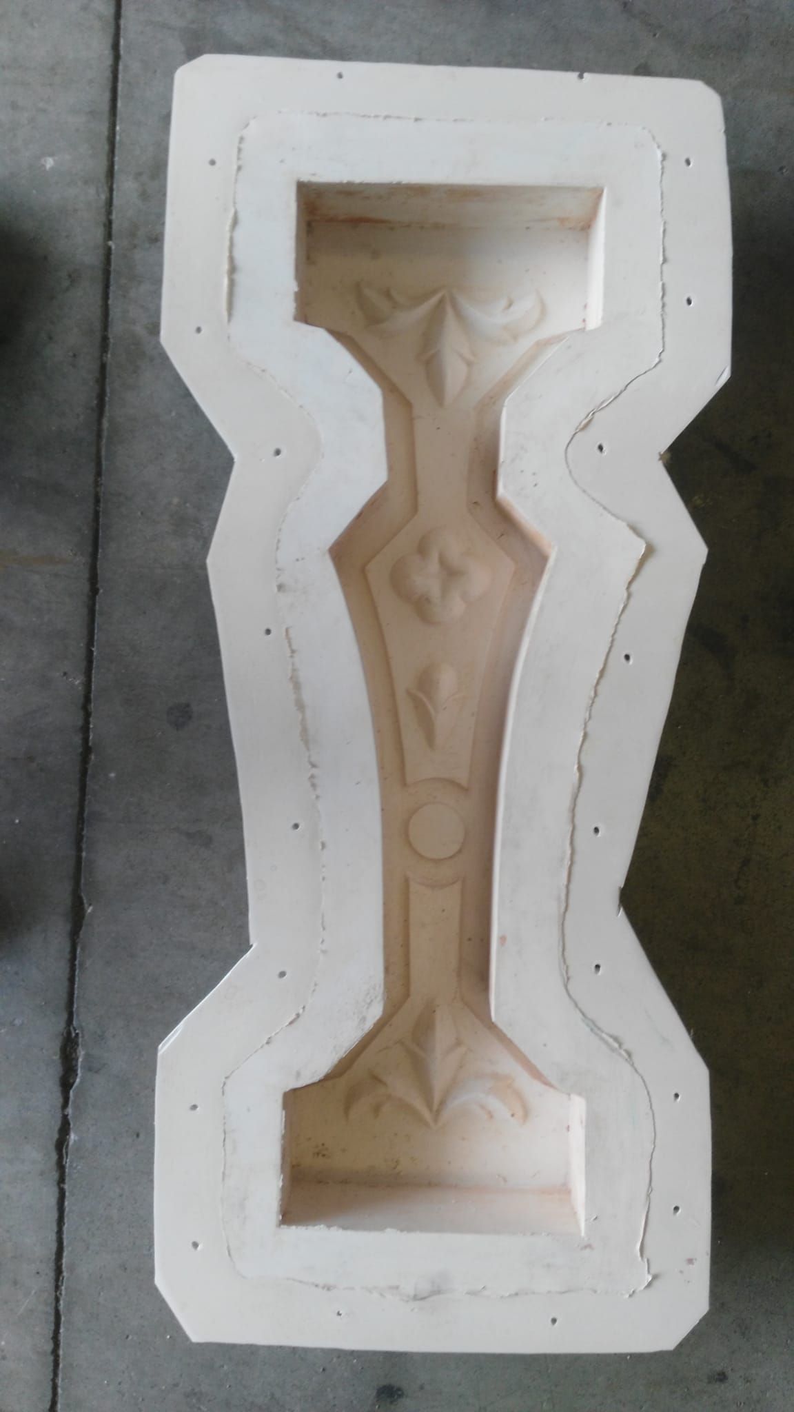 Molde de madera para elemento arquitectónico decorativo, con detalles de diseño empotrados.