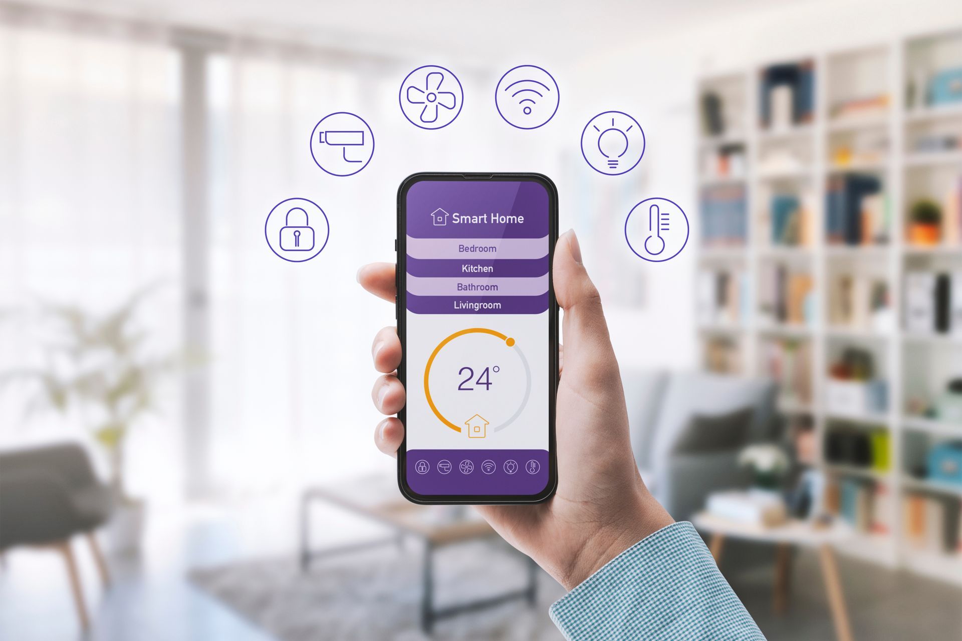 Une main tenant un smartphone avec une application domotique violette, entourée d'icônes d'appareils connectés.