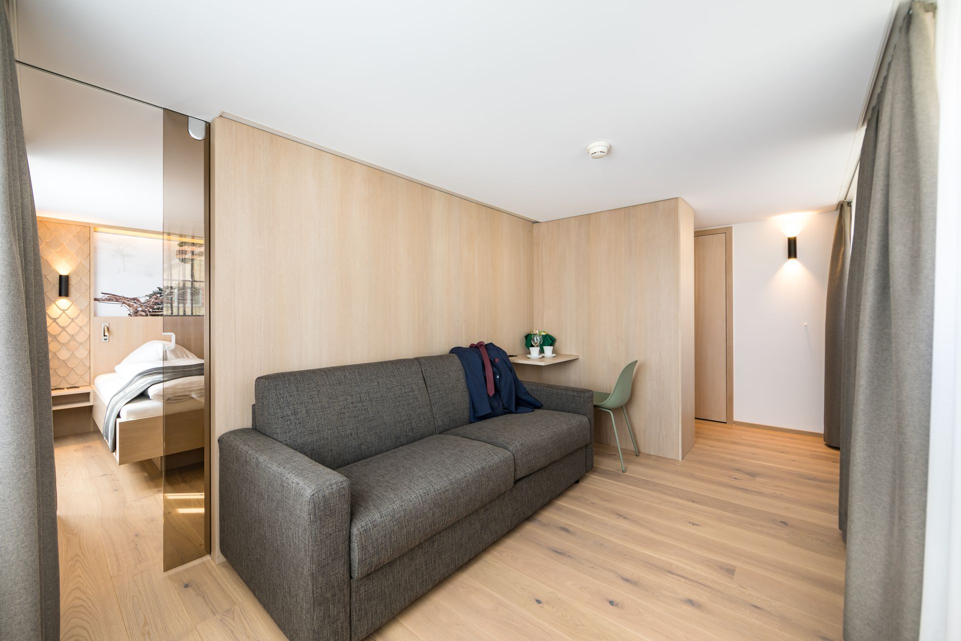 Ein Wohnzimmer mit einer Couch und einem Sessel darin