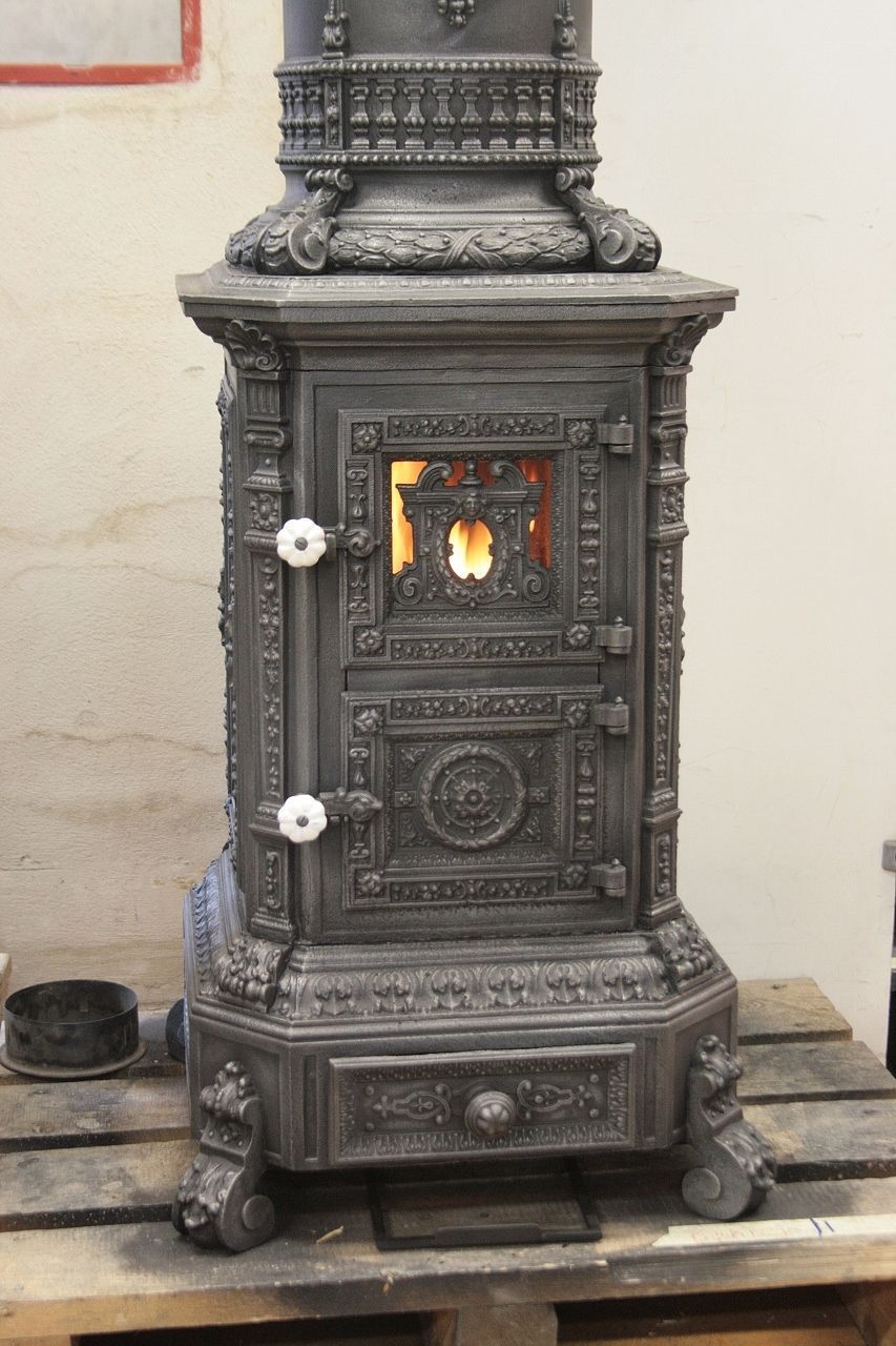Cast-iron stove with one tall fire door made from two smaller doors, original view preserved with doors closed