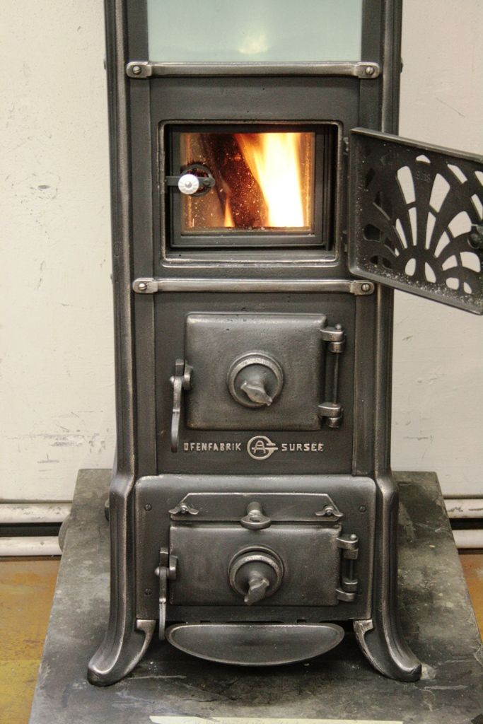 Sursee stove with refurbished heating compartment as loading door including glass door for view of flames